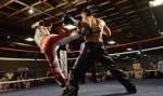 Chris Deakin lands a solid roundhouse to Alain Lebrun