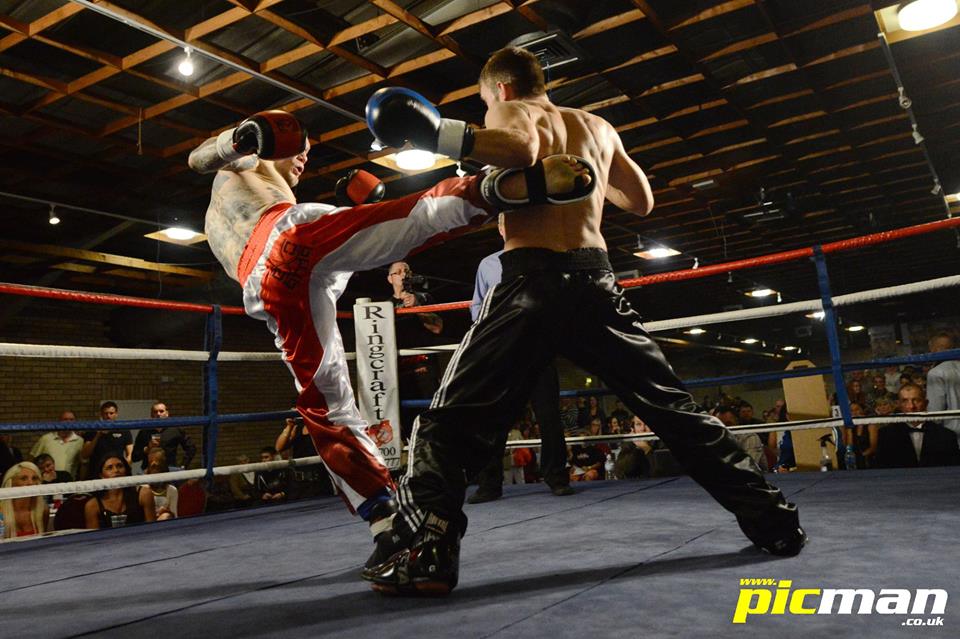 Chris Deakin lands a solid roundhouse to Alain Lebrun